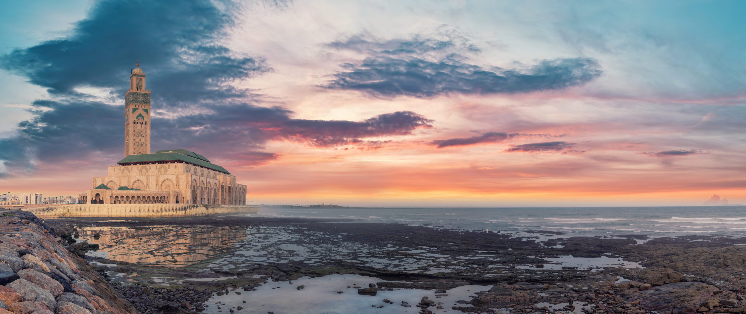 Casablanca, Morocco -April 2023: The Hassan II Mosque during sunset. Impressive architecture and intricate details showcase the country's rich cultural heritage and religious devotion.