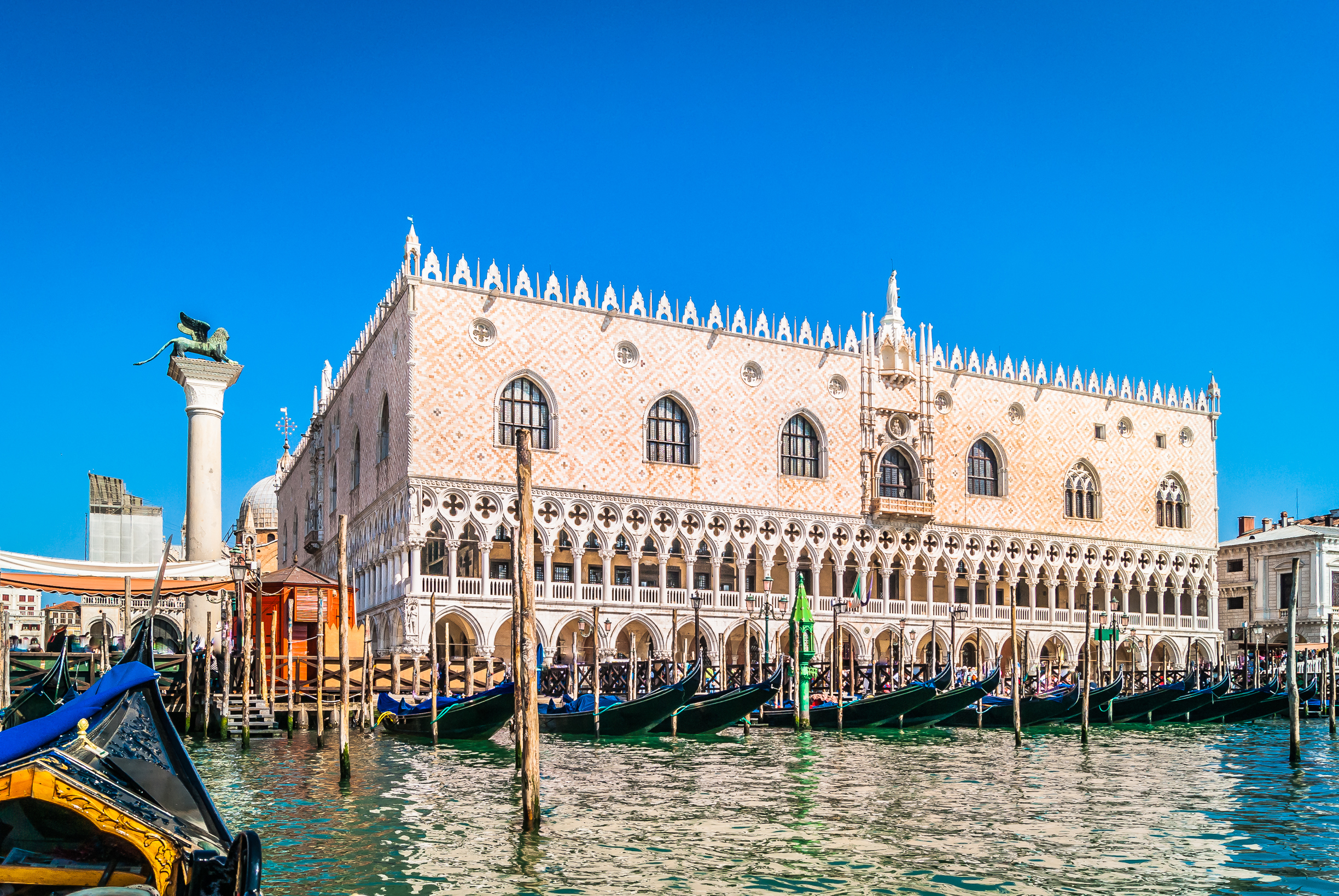 Waterfront view from gondola at amazing palace in touristic famous city of Venice, Italy.